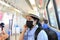 Asian woman wearing carbon mask for protect smog or PM 2.5 and viruses in The metro train MRT