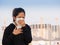 Asian woman wearing face mask and coughing
