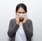 Asian woman wearing facial mask hands cover face and sneeze for protection from air pollution or virus epidemic