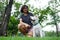 Asian woman wearing glass sitting with her white puppy