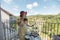 Asian woman wearing hat enjoying afternoon tea and dessert at balcony in English garden