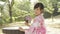 Asian woman wearing a kimono in front of Japanese wooden windows