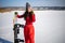 Asian Woman Wearing A Snowboard Mask And Tracksuit Rests With Snowboarding