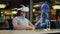 Asian woman wearing VR headset communicates with cartoon character via hologram