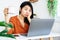 Asian woman worker tired from overworked hand holding cup of coffee looking at laptop feeling sleepy and bored with working