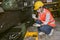 Asian woman worker working in heavy metal industry workshop wearing facemask for hygiene healthy safety