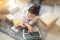 Asian woman working on laptop at home are arrange delivery packaging for customers