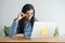 This asian woman is working on laptop in the office . On her face are expression surprise and happy to job success