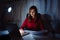 Asian woman working late at night reading document with laptop computer home office workhard