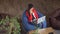 Asian woman working in loft sitting on bean bag chairs.