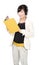 Asian woman with yellow book and headphones