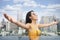 Asian woman in yellow swimsuit relax in rooftop swimming pool