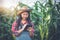 Asian women Agronomist and farmer  Using Technology for inspecting in Agricultural Corn Field