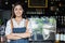 Asian women Barista smiling and using coffee machine in coffee shop counter - Working woman small business owner food and drink