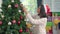 Asian women decorate Christmas tree at Christmas festival. Female teen happy smiling celebrate xmas winter holidays in living room