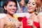 Asian women drinking cocktails in bar