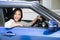 Asian women driving a car and smile happily with glad positive expression during the drive to travel journey,