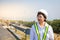 Asian women engineer stands confidently at outdoor on site power plant energy wind