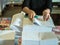 Asian women fold a piece of paper to ready to make a books.