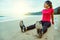 Asian women jogging workout on the beach. Sit down on the beach  fitness relax with stretch legs and Stretch arm