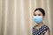 Asian women protect coronavirus by wearing mask and 75 percent alcohol and working in the home, stop go out home protect covid-19