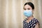 Asian women protect coronavirus by wearing mask and 75 percent alcohol and working in the home, stop go out home protect covid-19