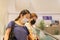 Asian women in protective mask standing on escalator in shopping mall.