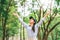 Asian women raise their hands to nature in the forest .people protect from deforestation and pollution or climate change Concept