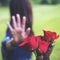 An Asian women rejecting a red rose flower from her boyfriend on Valentine`s day with nature