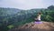 Asian women relax in the holiday. Play if yoga. On the Moutain rock cliff. Nature of mountain forests in Thailand. Young woman