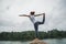 Asian women relax in the holiday. Play if yoga. On the rocks in the middle of the water