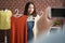 Asian women are showing off shirts for sale online. With photographers recording videos with their smartphones to share on