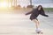 Asian women on skates board outdoors on beautiful summer day. Happy young women play surfskate at park on morning time. Sport