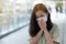 Asian women sneezing and wear surgical face masks to protect the covid-19 in public areas