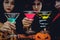 Asian women in spooky costume drinking cocktail in halloween celebration party