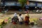 Asian women on the street market and selling bananas