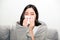 Asian women with stress that suffer from allergies and close the nose with tissue paper. Because of having sneezing all the time.