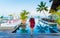 Asian women at a swimming pool at a luxury hotel, sunbed chair and umbrella