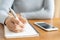 Asian women take notes with a pen in the office, business woman working on table