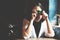 Asian women take a picture by film camera in coffee cafe, soft focus and low light picture