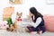 Asian women are teaching their dogs in the living room. Girl trianing shiba inu dog