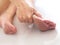 Asian women with tendon inflammation, muscles and nerves on feet, Heel pain and use hand massage to relieve