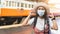 Asian women tourists at Bangkok train station. A female traveller wearing a mask while visiting a backpacker during the outbreak