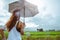 Asian women travel relax in the holiday. Women stand in rain umbrellas. On the meadow During the rainy season.Thailand