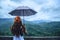 Asian women travel relax in the holiday. The women stood in rain umbrellas on the mountain. During the rainy season.Thailand