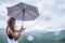 Asian women travel relax in the holiday. The women stood in rain umbrellas on the mountain. During the rainy season.Thailand