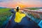 Asian women walk around the colorful grass at dusk in salt farm, Jeung-do Island, South Korea