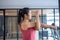 Asian women wearing sportswear standing, stretching arms, preparing muscles to stretch to prepare the body to be ready to exercise