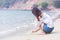 Asian women write sand on the beach