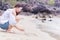 Asian women write sand on the beach